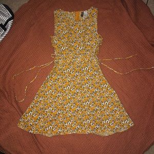 Yellow floral dress with lace up sides.